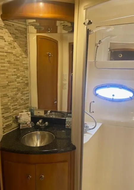 Slide: The Image of 2001 Carver 466 Motor Yacht bathroom with sink, mirror, and shower. - 73