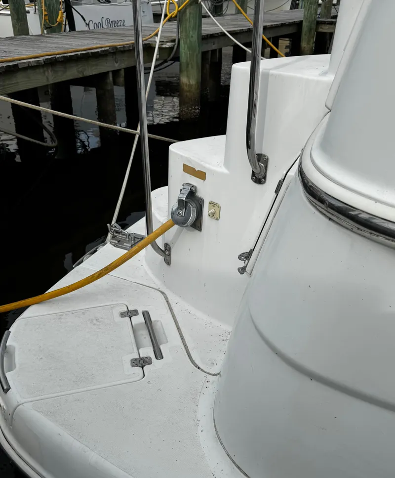 Slide: The Image of 2001 Carver 466 Motor Yacht docked, showing power connection and deck details. - 9