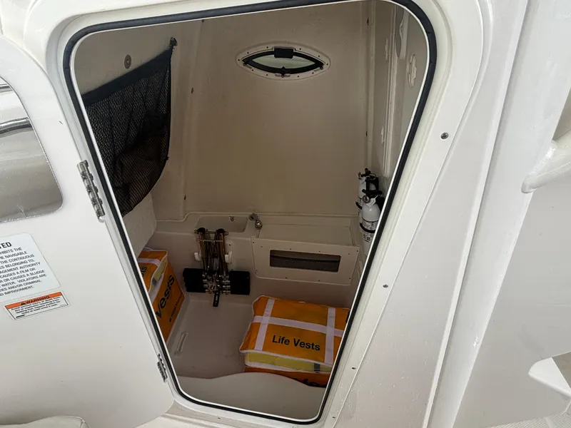 Slide: The Image of 2023 Sailfish 272 CC cabin with life vests and safety equipment. - 13