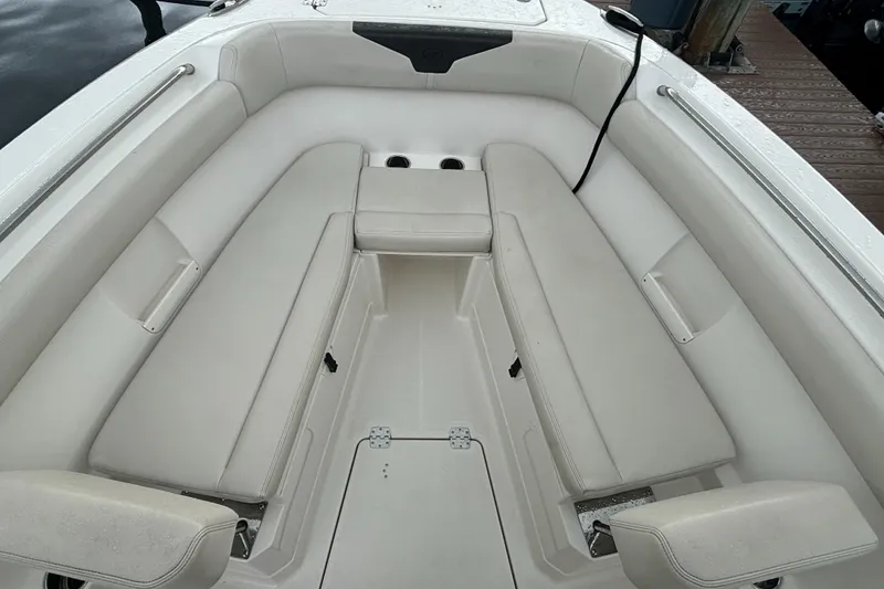 Slide: The Image of 2023 Sailfish 272 CC boat interior with white cushioned seating and cup holders. - 15