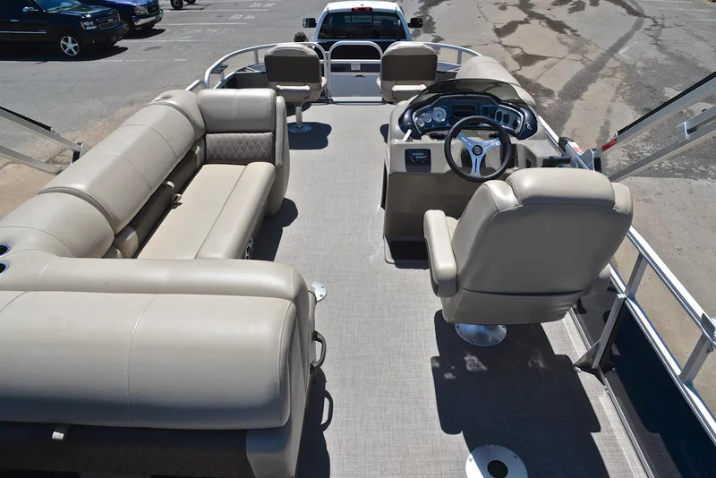 Slide: The Image of 2023 Sun Tracker Fishin Barge 20 DLX interior with seating and steering console. - 18