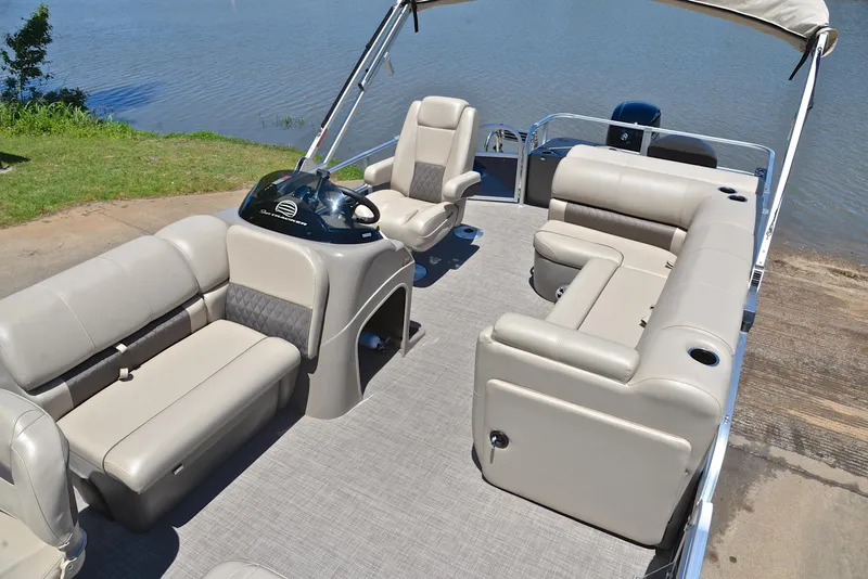 Slide: The Image of 2023 Sun Tracker Fishin Barge 20 DLX pontoon boat with spacious seating and helm, near water. - 22