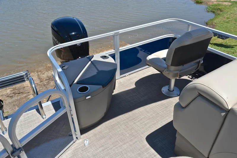 Slide: The Image of 2023 Sun Tracker Fishin Barge 20 DLX pontoon boat interior with seating and motor. - 23