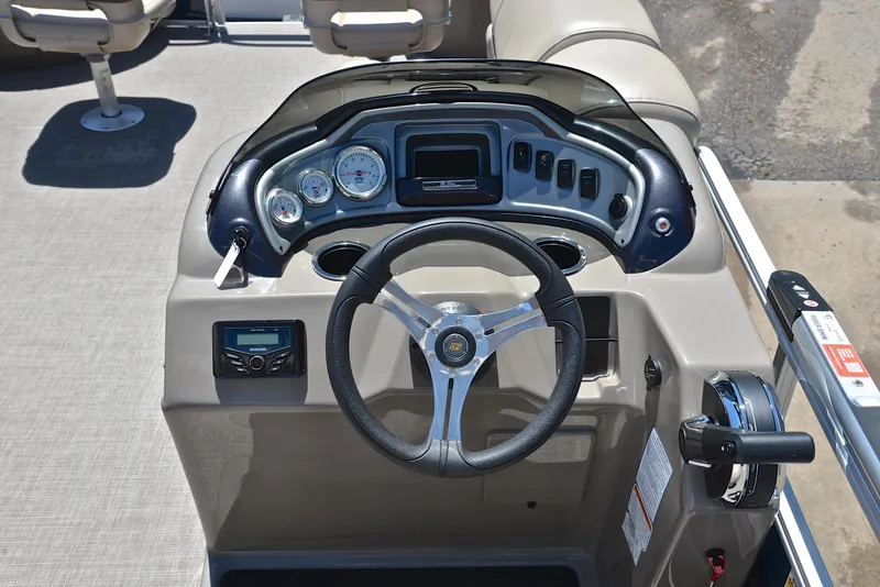 Slide: The Image of 2023 Sun Tracker Fishin Barge 20 DLX dashboard with steering wheel and control panel. - 26