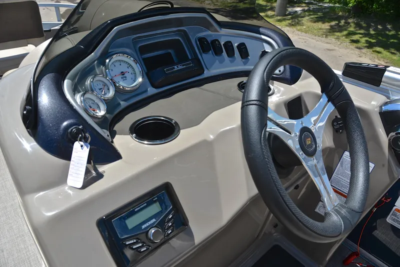 Slide: The Image of 2023 Sun Tracker Fishin Barge 20 DLX dashboard with steering wheel and gauges. - 27