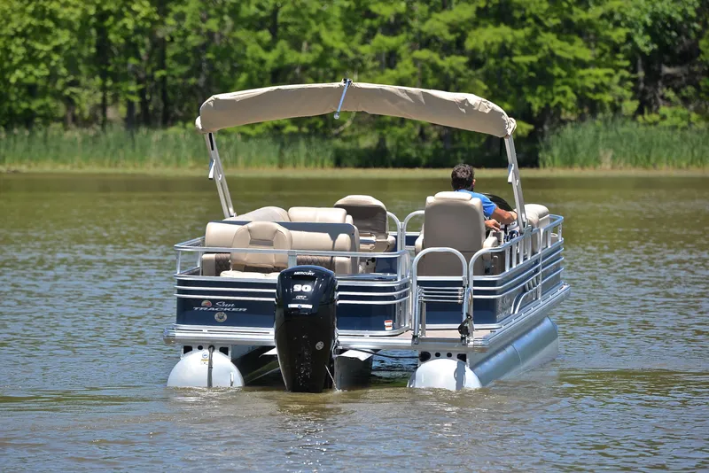 Slide: The Image of 2023 Sun Tracker Fishin Barge 20 DLX pontoon boat on a calm lake. - 7