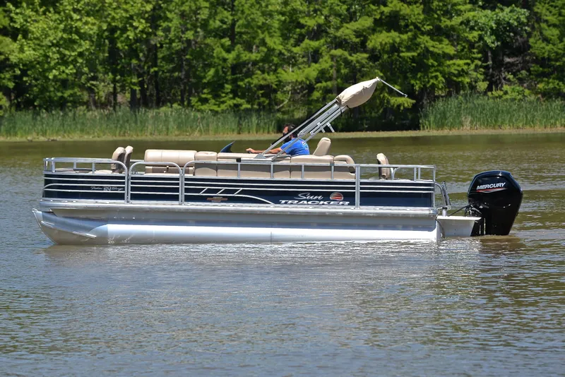 Slide: The Image of 2023 Sun Tracker Fishin Barge 20 DLX pontoon boat on a calm lake. - 8