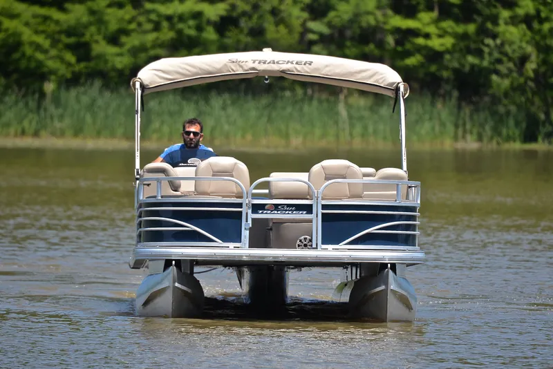 Slide: The Image of 2023 Sun Tracker Fishin Barge 20 DLX pontoon boat on a calm lake. - 9