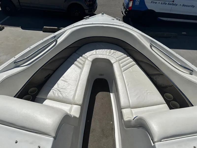Slide: The Image of 2004 Cobalt 282 boat interior with white leather seating and cup holders. - 10