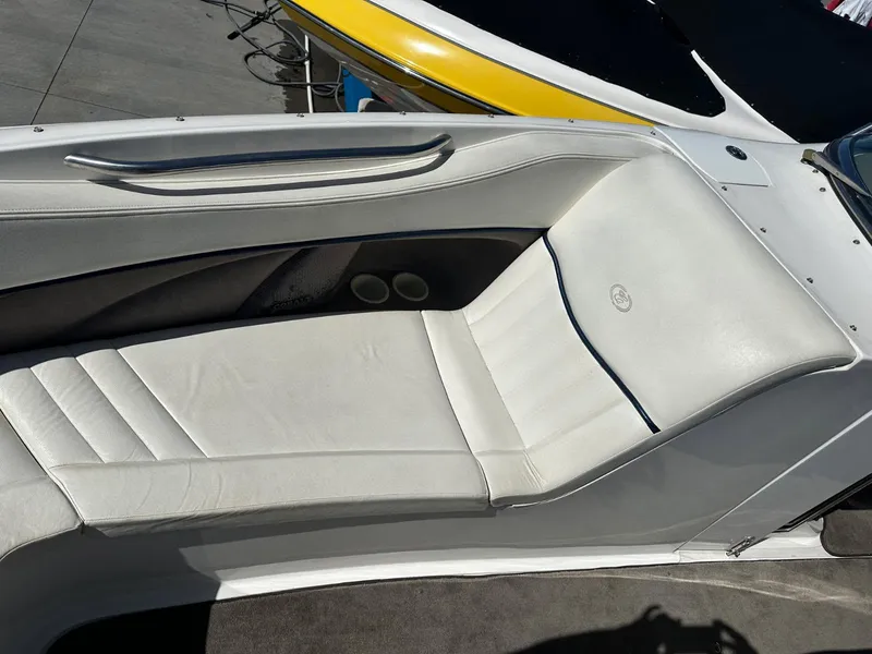 Slide: The Image of 2004 Cobalt 282 boat interior with white leather seating and cup holders. - 12