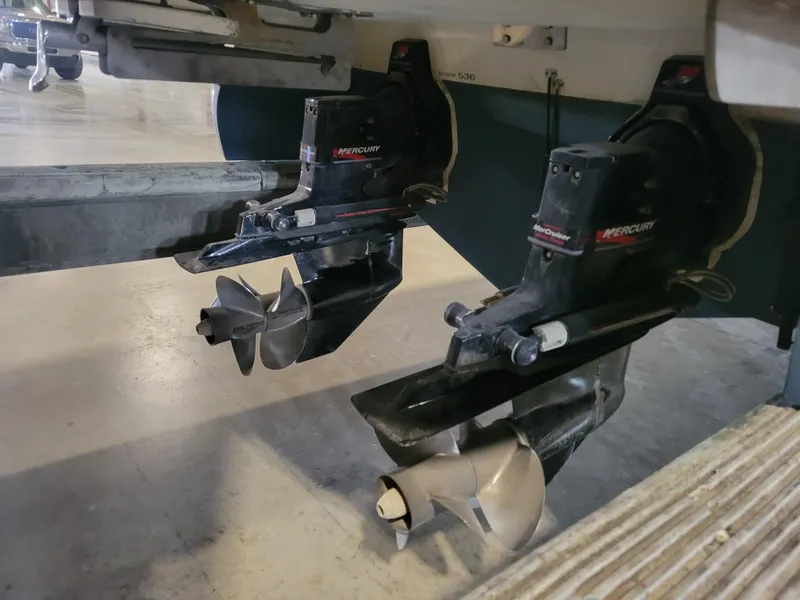 Slide: The Image of Twin Mercury outboard motors on a 2004 Cobalt 282 boat in a garage. - 18