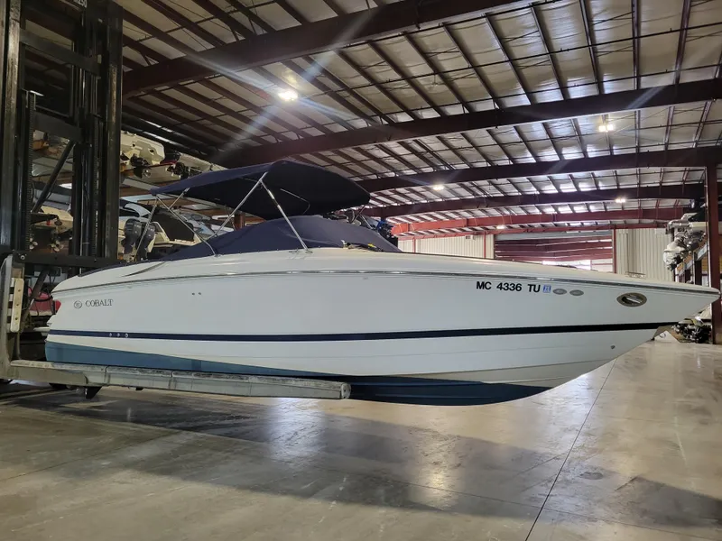 Slide: The Image of 2004 Cobalt 282 boat in indoor storage facility, side view. - 2