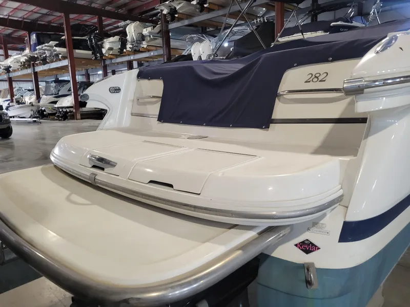 Slide: The Image of 2004 Cobalt 282 boat in storage, featuring a spacious swim platform. - 3