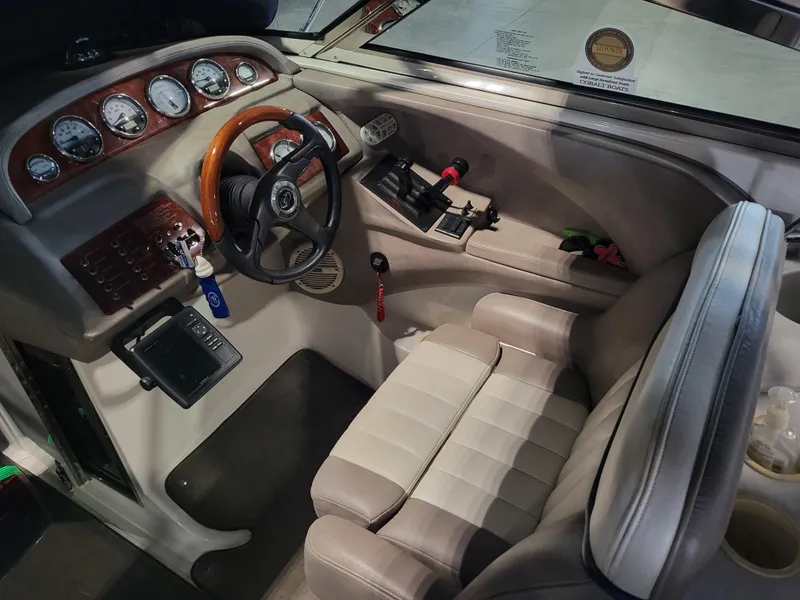 Slide: The Image of 2004 Cobalt 282 boat cockpit with steering wheel, gauges, and control panel. - 4
