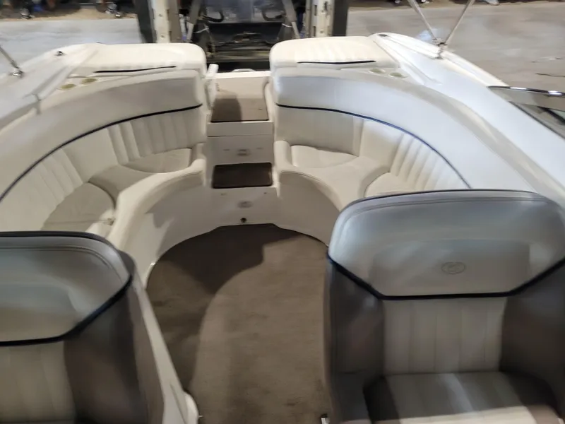 Slide: The Image of Interior of a 2004 Cobalt 282 boat with white seating and carpeted floor. - 7