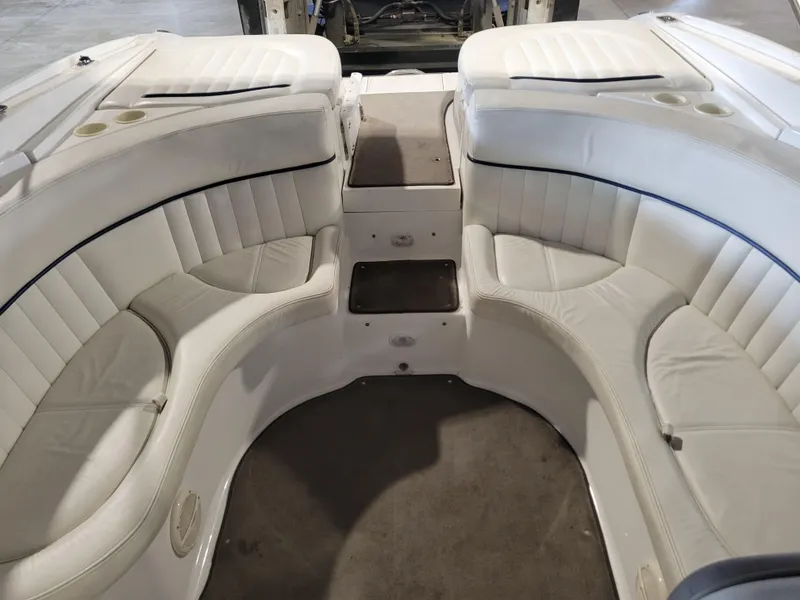 Slide: The Image of 2004 Cobalt 282 boat interior with white leather seating and carpeted floor. - 8