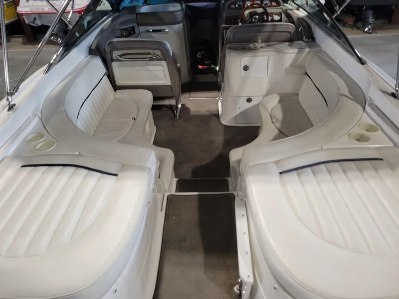 Slide: The Image of Interior of a 2004 Cobalt 282 boat with white seating and dashboard. - 9
