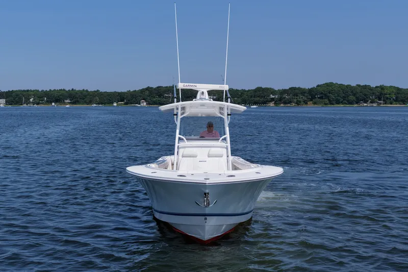 Slide: The Image of 2013 Regulator 34 Center Console boat cruising on a calm lake. - 12