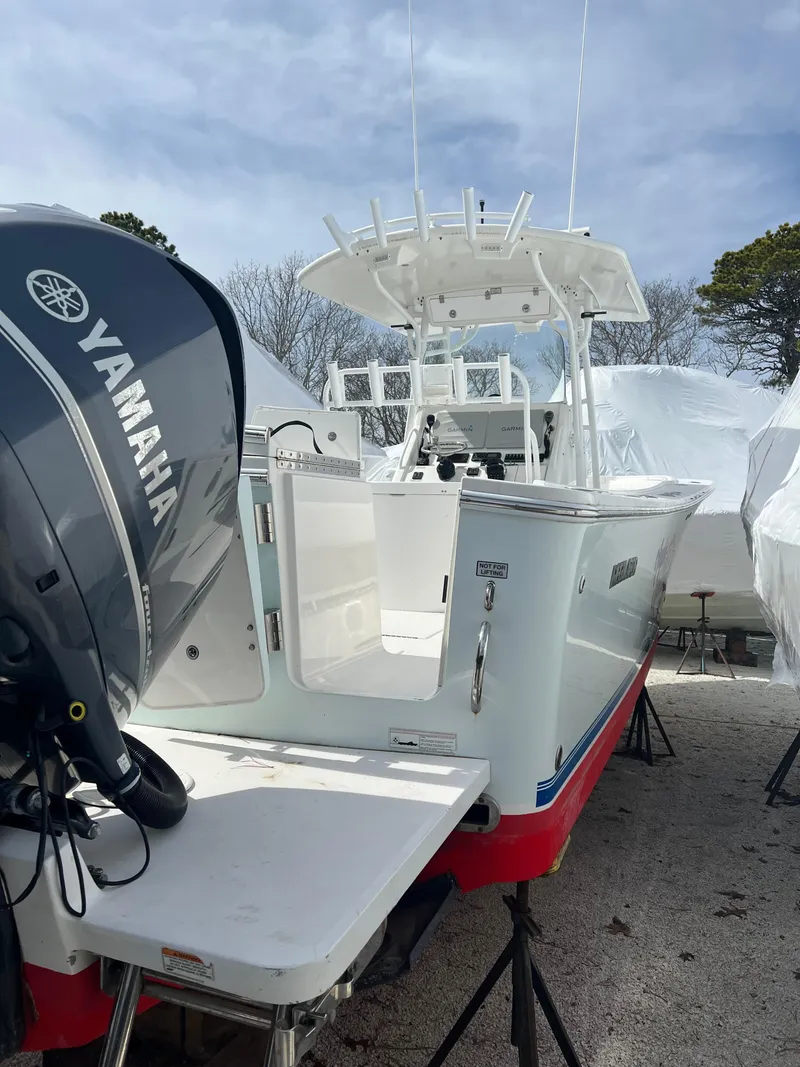 Slide: The Image of 2013 Regulator 34 Center Console boat with Yamaha engine, docked outdoors. - 17