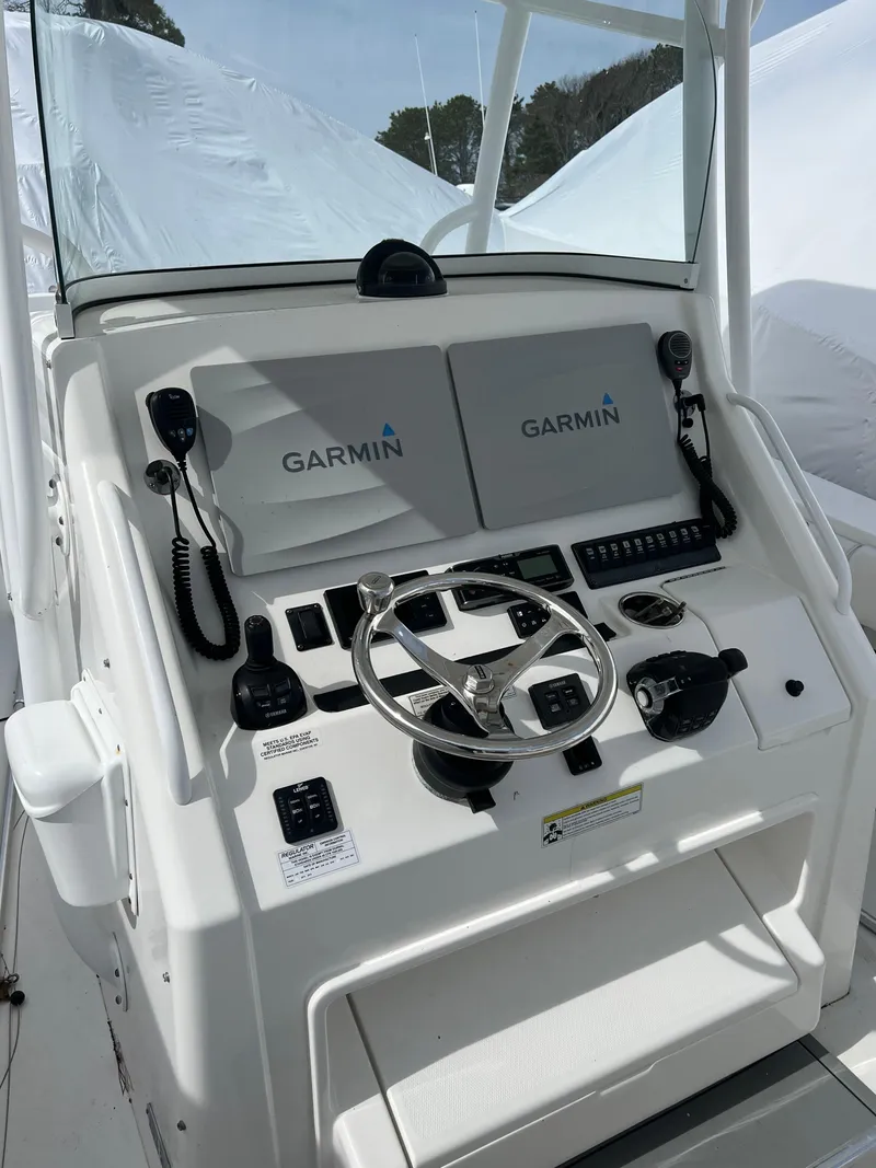 Slide: The Image of 2013 Regulator 34 Center Console helm with Garmin navigation system and steering wheel. - 20