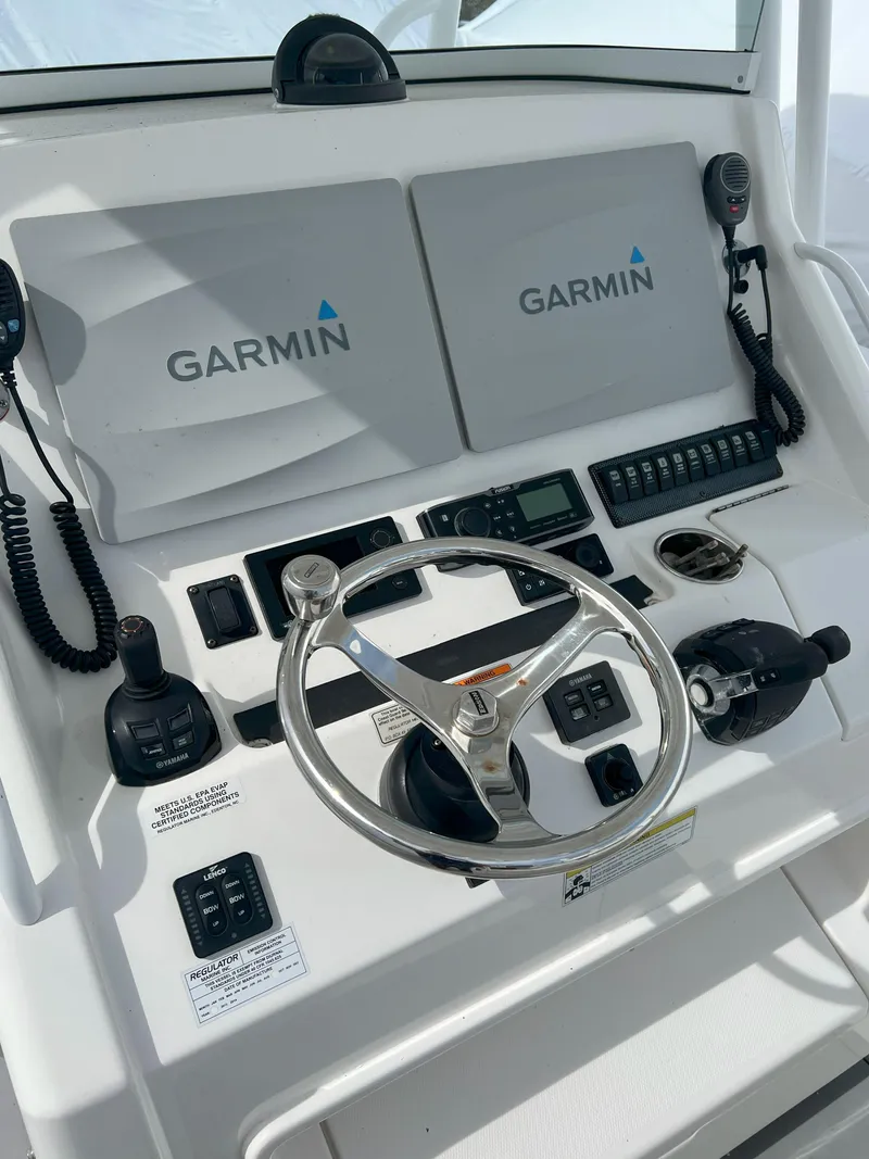Slide: The Image of 2013 Regulator 34 Center Console helm with Garmin navigation system and controls. - 21