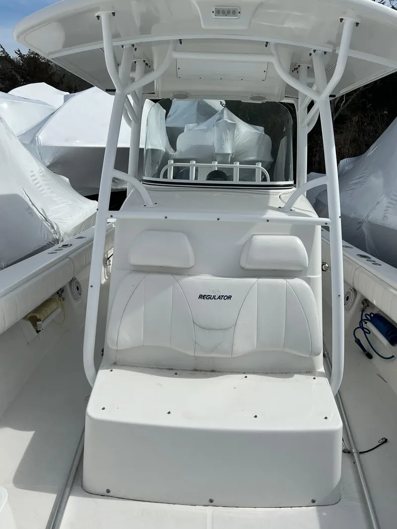 Slide: The Image of 2013 Regulator 34 Center Console boat with white seating and T-top. - 26