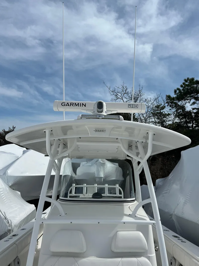 Slide: The Image of 2013 Regulator 34 Center Console boat with Garmin radar, under a partly cloudy sky. - 27