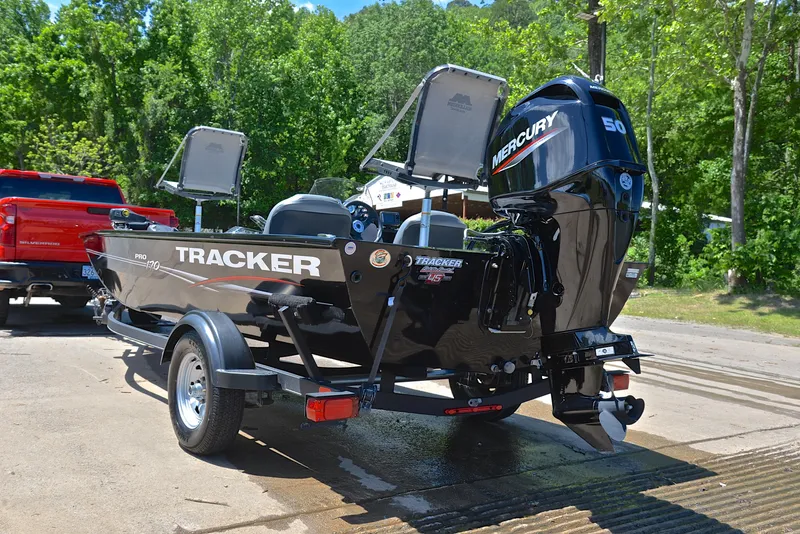 Slide: The Image of 2023 Bass Tracker Pro 170 boat with Mercury engine on trailer, outdoors. - 12