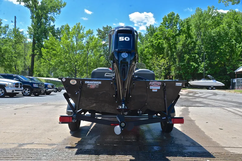 Slide: The Image of 2023 Bass Tracker Pro 170 boat rear view, parked outdoors on a sunny day. - 13