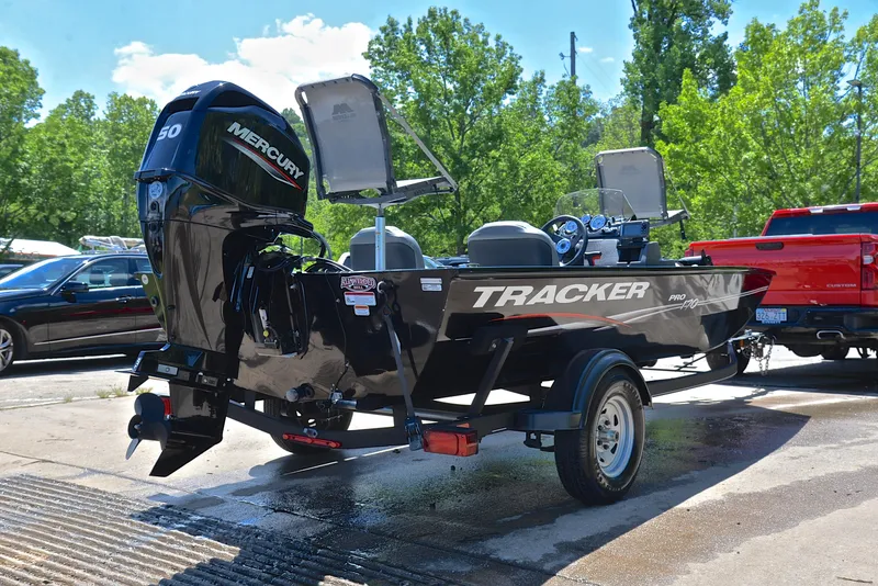 Slide: The Image of 2023 Bass Tracker Pro 170 boat with Mercury engine, parked outdoors. - 14
