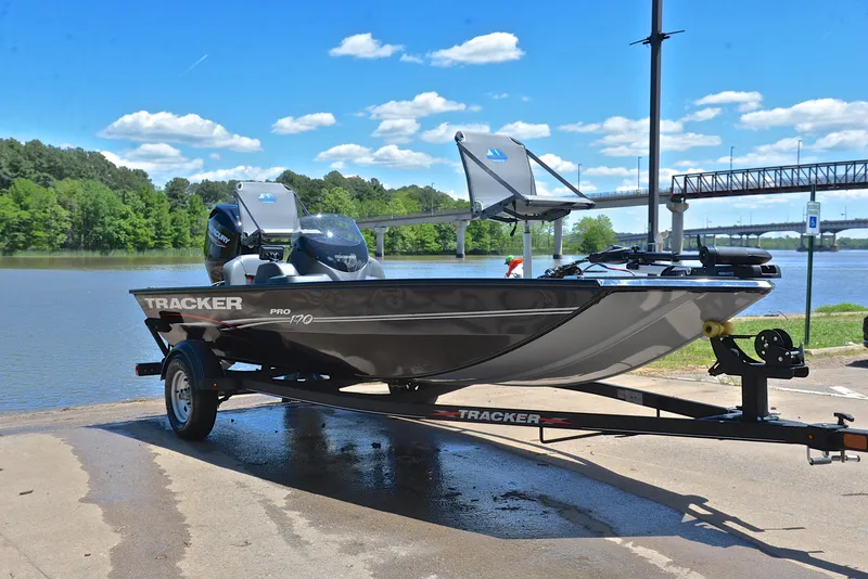 Slide: The Image of 2023 Bass Tracker Pro 170 boat on trailer by a scenic lake. - 16