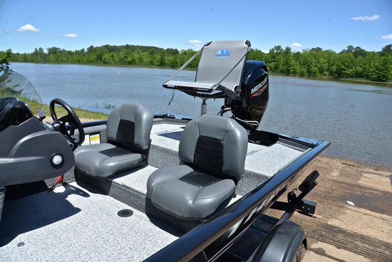 Slide: The Image of 2023 Bass Tracker Pro 170 boat with dual seats by a scenic lake. - 18