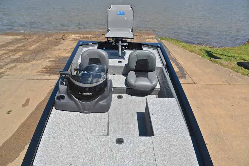 Slide: The Image of 2023 Bass Tracker Pro 170 boat on a ramp, featuring gray seating and a sleek design. - 23