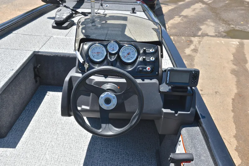 Slide: The Image of 2023 Bass Tracker Pro 170 dashboard with steering wheel and gauges. - 25