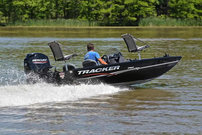 Slide: The Image of 2023 Bass Tracker Pro 170 boat speeding on a lake with Mercury engine. - 5