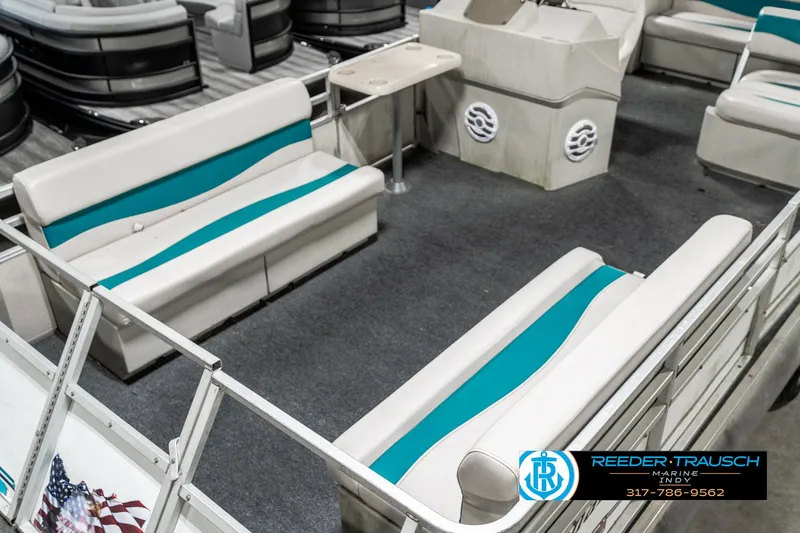Slide: The Image of 1989 Crest 25 Savannah II pontoon boat interior with teal and white seating. - 11