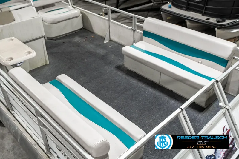 Slide: The Image of 1989 Crest 25 Savannah II pontoon boat interior with teal-striped seating. - 12