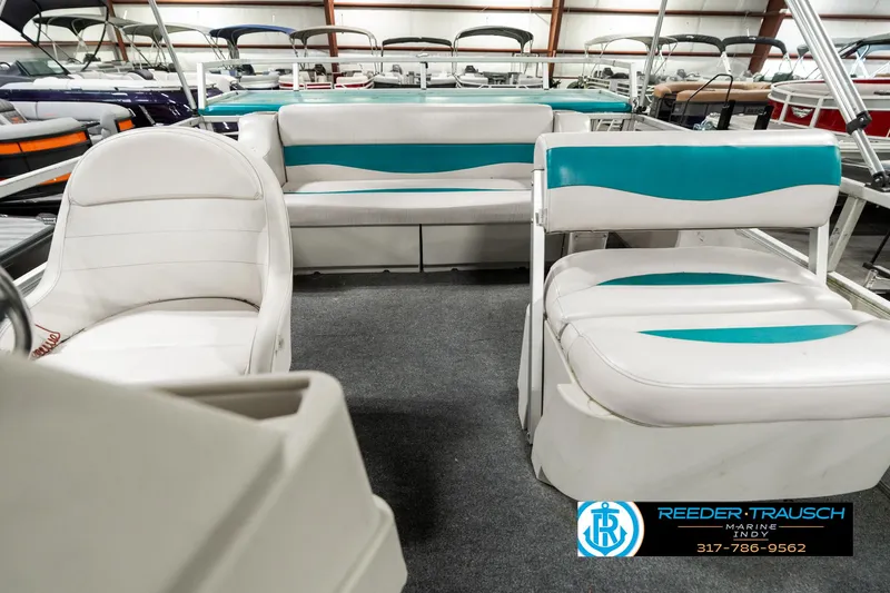 Slide: The Image of 1989 Crest 25 Savannah II pontoon boat interior with white and teal seating. - 16