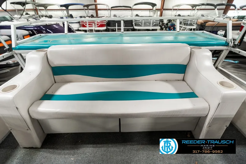 Slide: The Image of Crest 25 Savannah II 1989 boat interior with teal and white seating. - 17