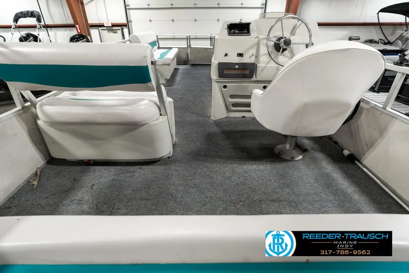 Slide: The Image of Interior of 1989 Crest 25 Savannah II boat with white seating and steering wheel. - 18