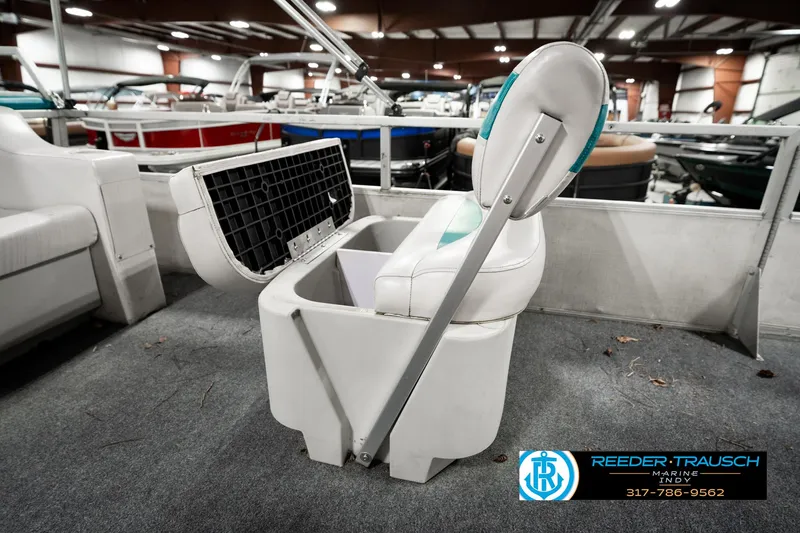Slide: The Image of 1989 Crest 25 Savannah II boat seat with storage compartment, displayed indoors. - 25