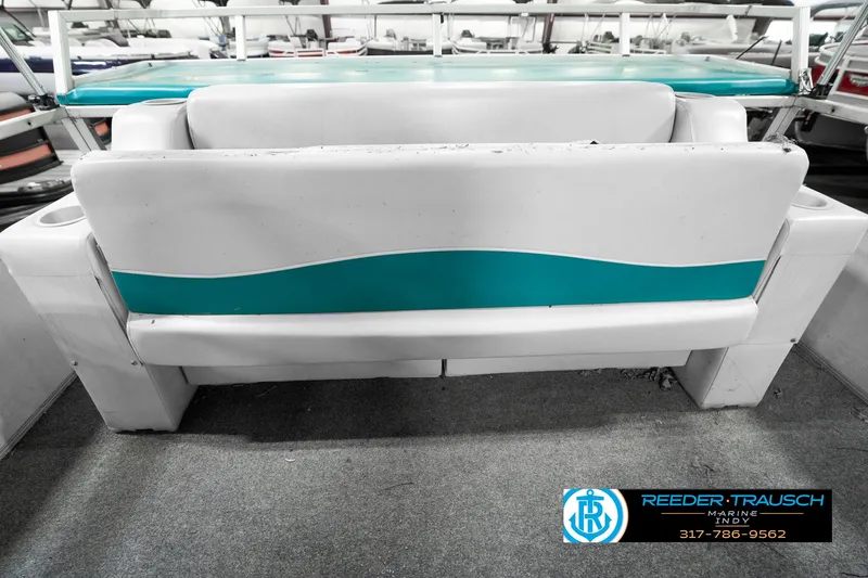 Slide: The Image of 1989 Crest 25 Savannah II boat interior with teal and white seating. - 27