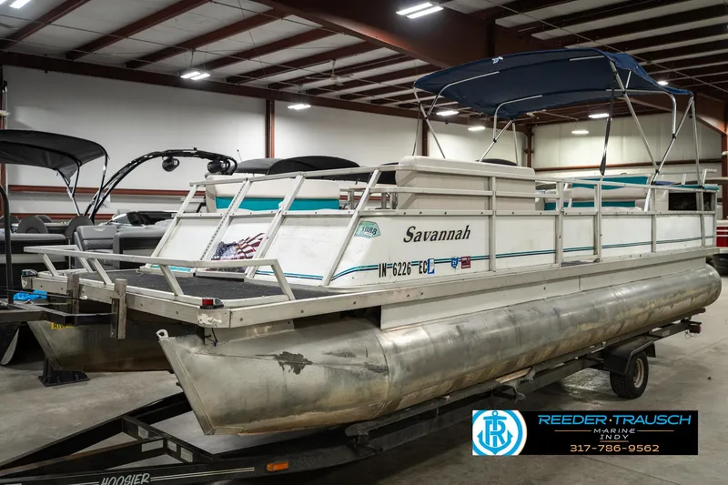 Slide: The Image of 1989 Crest 25 Savannah II pontoon boat in indoor storage on a trailer. - 3