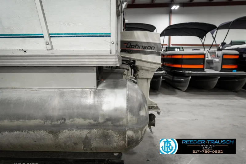 Slide: The Image of 1989 Crest 25 Savannah II pontoon boat with Johnson outboard motor in a showroom. - 37