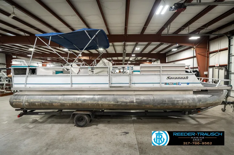 Slide: The Image of 1989 Crest 25 Savannah II pontoon boat in a warehouse, side view. - 6