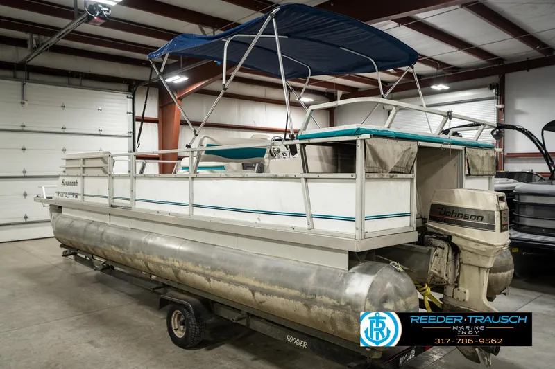 Slide: The Image of 1989 Crest 25 Savannah II pontoon boat with canopy in indoor storage. - 9