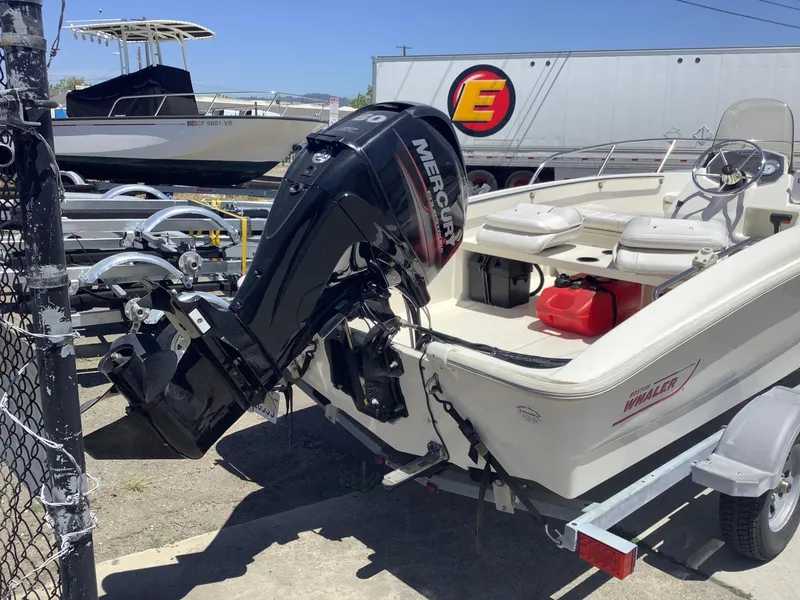 Slide: The Image of 2016 Boston Whaler 150 Super Sport boat with Mercury outboard motor on trailer. - 4