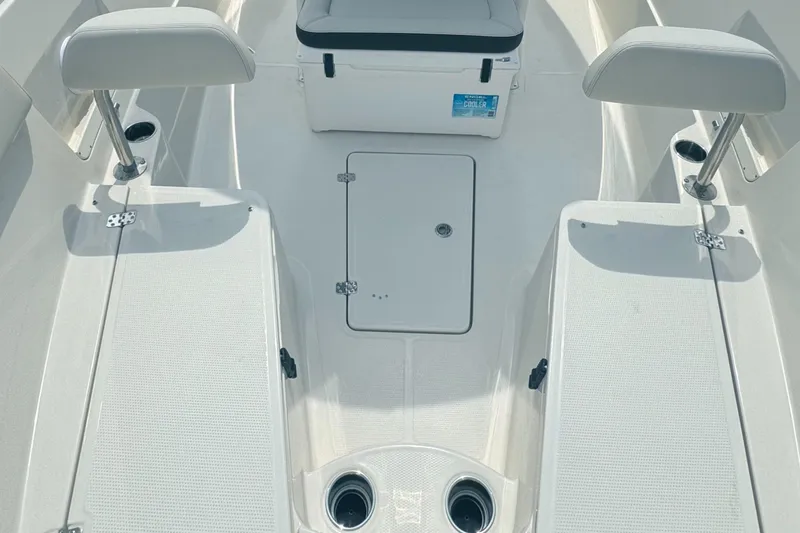 Slide: The Image of 2024 Sailfish 290 CC boat interior with seating and storage compartments. - 11