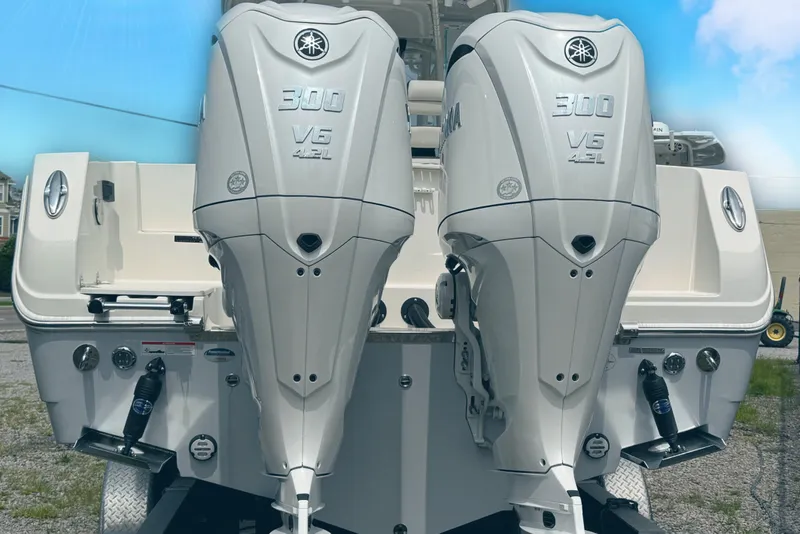 Slide: The Image of 2024 Sailfish 290 CC with twin Yamaha 300 V6 outboard engines, rear view. - 5
