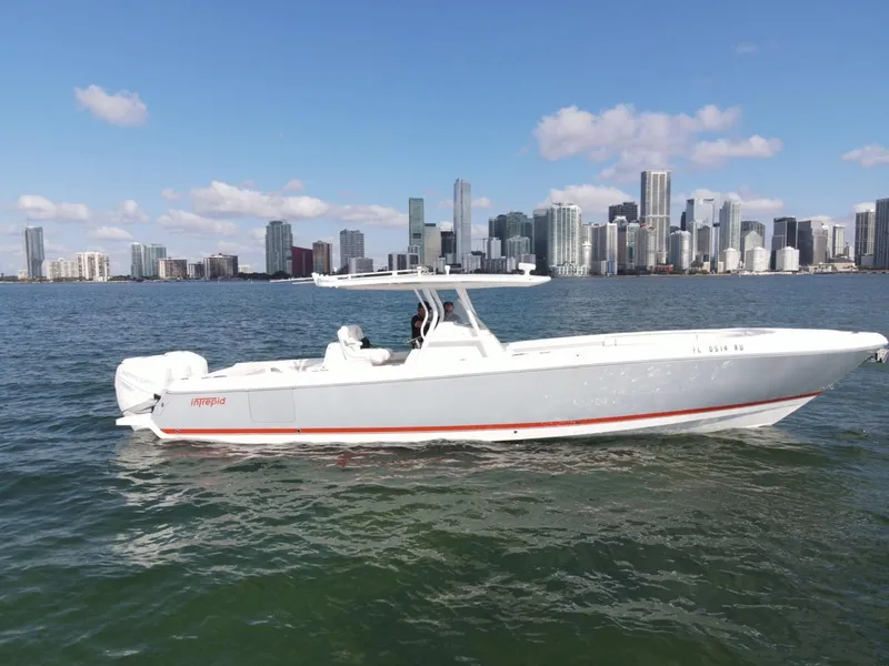 The Image of 2016 Intrepid 375 CC boat on water with city skyline in background. - 0